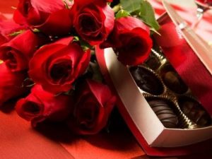 red roses with a box of chocolates